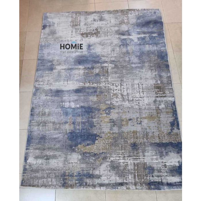 שטיח אבסטרקטי מודרני מעוצב דגם קארינה 01 בצבע כחול, אפור, בז' ושמנת. השטיח היוקרתי העשוי היטסט-ויסקוזה מתאים לסלון, חדר שינה, מסדרון, חדר ילדים ותינוקות, חדר אורחים, פינת ישיבה, פינת משחקים, פינת אוכל, חדר עבודה ומשרד.