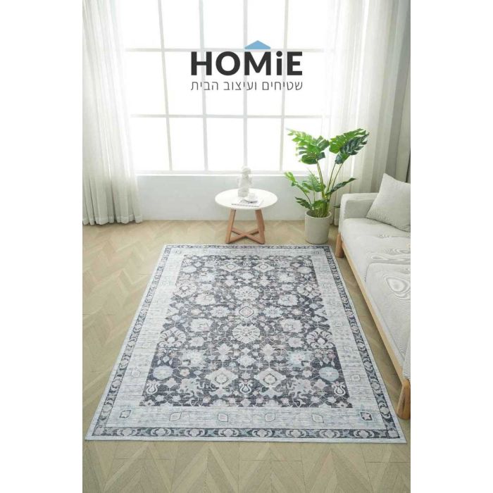שטיח דגם אנדראס וינטג' קלאסי מודרני בגווני אפור אבן עם דוגמת מדליונים פרחונית, פרוש במלואו על פרקט לצד ספה בסלון