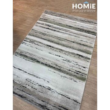 שטיח סלון אבסטרקטי מודרני דגם זורה בגווני שמנת, אפור, שחור וירוק מונח בשלמותו על רצפת פרקט