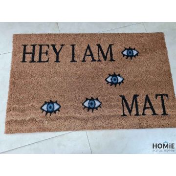 שטיח כניסה-סף דקורטיבי מודרני יוקרתי לבית דגם עיניים Hey I'm A Mat בצבע שחור כחול. השטיח עשוי 100% קוקוס טבעי.