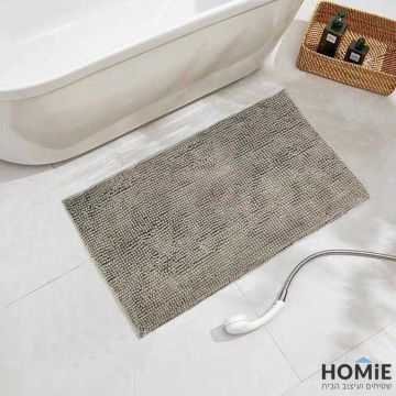 שטיח אמבטיה שניל מודרני פונפונים אבן דגם מלודי 06. השטיח היוקרתי מתאים גם לשירותים ושאר חלל הבית. הוא מגיע בקונסטלציית פונפונים נעימה למגע ושכבה בתחתית שמונעת החלקה. 